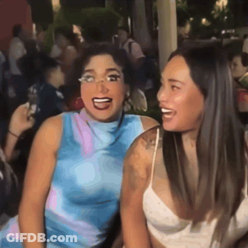 Two Women Are Posing For A Picture And One Has Glasses On GIF