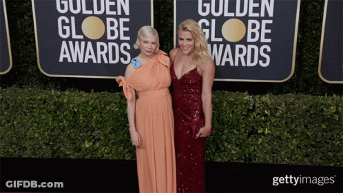 Two Women Are Posing For A Picture On The Red Carpet For The Golden Globe Awards GIF