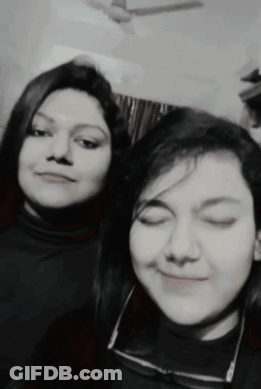 Two Women Are Posing For A Picture Together With Their Eyes Closed GIF