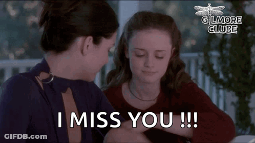 Two Women Are Sitting At A Table And One Of Them Is Saying I Miss You . GIF