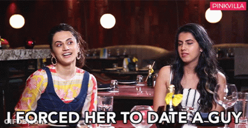 Two Women Are Sitting At A Table In A Restaurant And One Of Them Is Saying " I Forced Her To Date A Guy " GIF