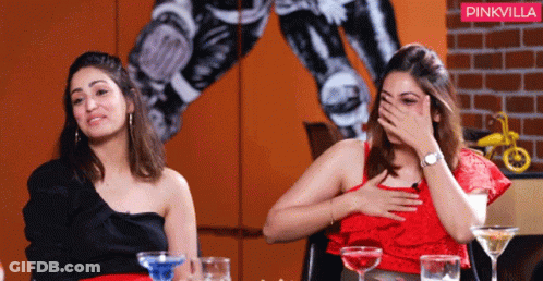 Two Women Are Sitting At A Table With A Pinkvilla Logo In The Background GIF