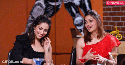 Two Women Are Sitting At A Table With Drinks And A Pinkvilla Logo In The Background GIF