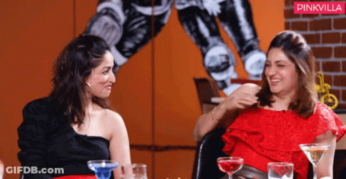 Two Women Are Sitting At A Table With Drinks And A Pinkvilla Logo In The Background GIF