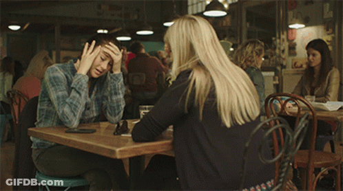 Two Women Are Sitting At A Table With The Words " I Need To Get Out Of This Town As Soon As Possible " Below Them GIF