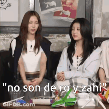 Two Women Are Sitting At A Table With The Words No Son De Roy Y Zahi Written On The Table . GIF