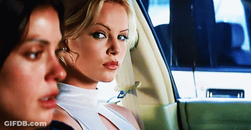 Two Women Are Sitting In A Car One Is Wearing A White Tank Top GIF