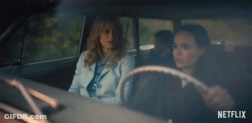 Two Women Are Sitting In A Car With Netflix Written On The Bottom GIF