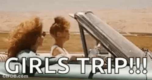 Two Women Are Sitting In A Car With The Words `` Girls Trip ! '' Written On The Side . GIF