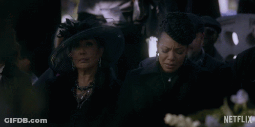 Two Women Are Sitting In A Crowd With A Netflix Logo Behind Them GIF