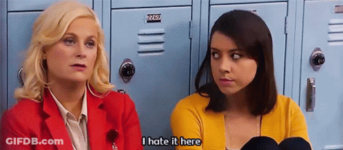 Two Women Are Sitting In Front Of Lockers And One Of Them Is Saying I Hate It Here GIF