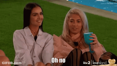 Two Women Are Sitting Next To Each Other And One Of Them Is Holding A Wine Glass And The Other Is Saying " Oh No " GIF