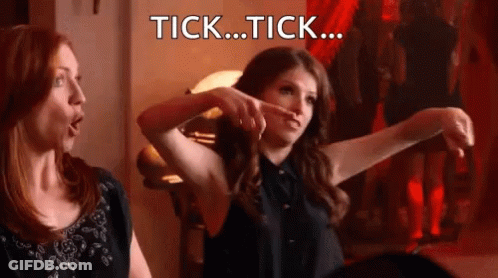 Two Women Are Sitting Next To Each Other And One Of Them Is Pointing At The Other With The Words Tick ... Tick ... Writt GIF