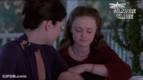 Two Women Are Sitting Next To Each Other And The Words Gilmore Clube Are On The Bottom GIF