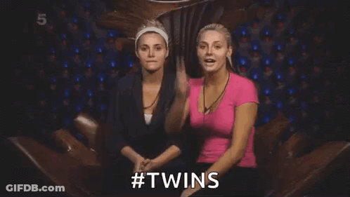Two Women Are Sitting Next To Each Other In A Chair And One Of Them Is Holding A Card In Her Hand . GIF