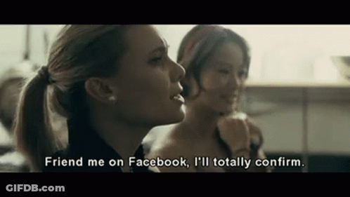 Two Women Are Sitting Next To Each Other In A Kitchen And One Of Them Is Talking About Facebook . GIF