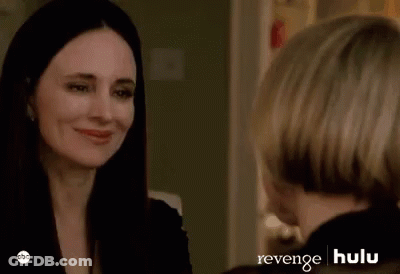 Two Women Are Sitting Next To Each Other In A Room And Looking At Each Other . GIF