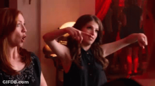 Two Women Are Sitting Next To Each Other In A Room . GIF