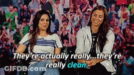 Two Women Are Sitting Next To Each Other In Front Of A Crowd And They Are Actually Really Clean GIF