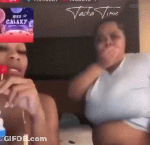 Two Women Are Sitting Next To Each Other In Front Of A Screen That Says ' Galaxy ' On It . GIF