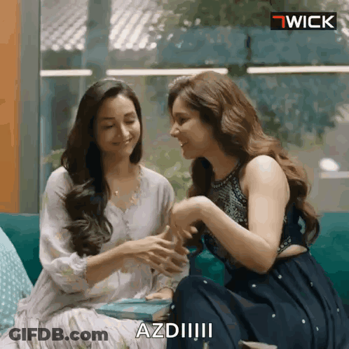 Two Women Are Sitting Next To Each Other On A Couch And One Of Them Is Saying Azdii GIF