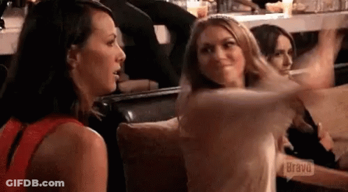 Two Women Are Sitting Next To Each Other On A Couch And Talking To Each Other . GIF