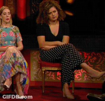 Two Women Are Sitting Next To Each Other With Their Legs Crossed And One Is Wearing Polka Dot Pants GIF