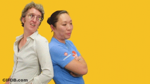 Two Women Are Standing Back To Back With The Words " You Got My Back " Behind Them GIF