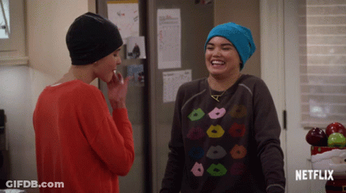 Two Women Standing In Kitchen With Netflix Sign GIF