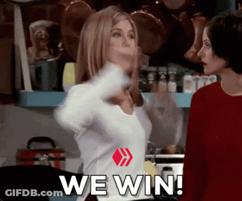 Two Women Are Standing In A Kitchen With The Words We Win Written On Their Shirts GIF