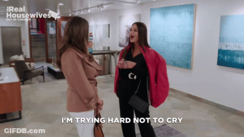 Two Women Are Standing In A Room With The Words I 'M Trying Hard Not To Cry GIF