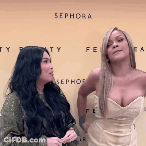 Two Women Are Standing In Front Of A Wall That Says Sephora GIF