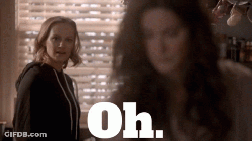 Two Women Standing In Front Of Window Saying Oh GIF