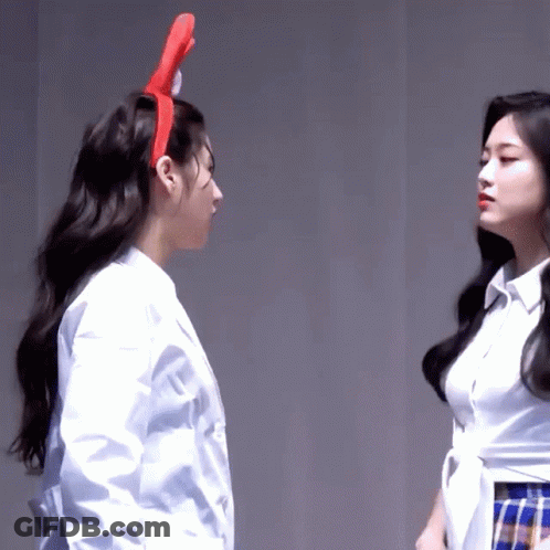 Two Women Are Standing Next To Each Other And One Has A Red Headband On GIF