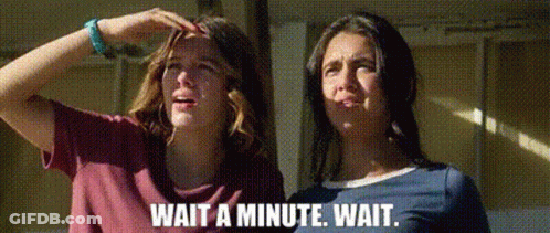 Two Women Are Standing Next To Each Other And One Of Them Is Holding Her Head . GIF