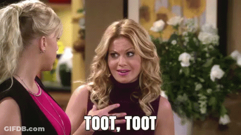 Two Women Are Standing Next To Each Other And One Of Them Is Saying Toot Toot . GIF