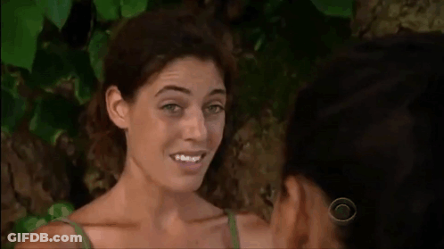 Two Women Are Standing Next To Each Other And Smiling At Each Other In Front Of A Tree . GIF