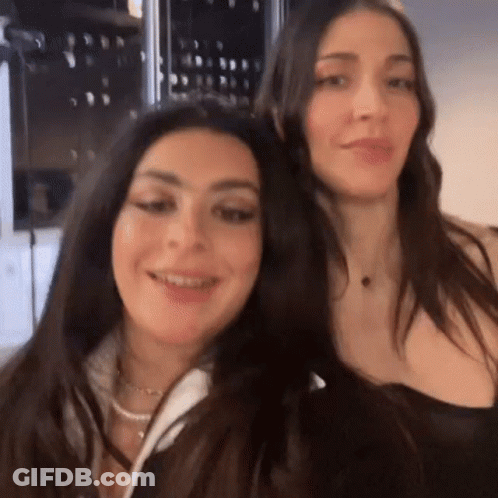 Two Women Are Standing Next To Each Other And Smiling . GIF