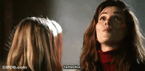 Two Women Are Standing Next To Each Other And Talking To Each Other . GIF