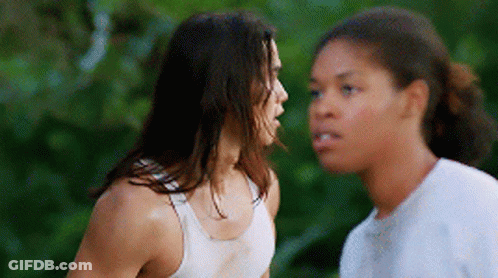 Two Women Are Standing Next To Each Other And Talking To Each Other GIF