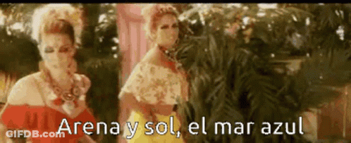 Two Women Are Standing Next To Each Other And The Words Arena Y Sol El Mar Azul Are Visible GIF