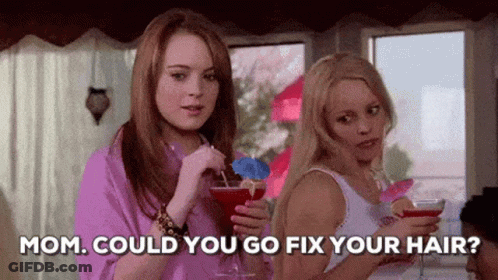 Two Women Are Standing Next To Each Other Holding Drinks And Talking . GIF