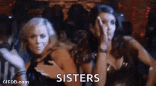 Two Women Are Standing Next To Each Other In A Dark Room And The Word Sisters Is Written On The Screen . GIF