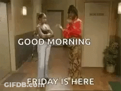 Two Women Are Standing Next To Each Other In A Hallway And Talking . GIF