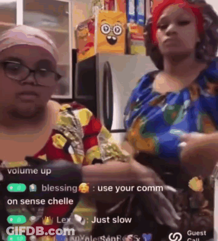 Two Women Are Standing Next To Each Other In A Kitchen And One Of Them Is Holding A Bottle Of Water . GIF
