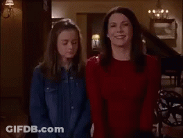 Two Women Are Standing Next To Each Other In A Room . GIF