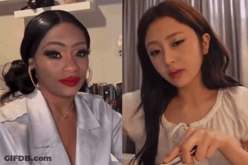Two Women Are Standing Next To Each Other In A Room . One Of The Women Is Wearing Red Lipstick . GIF