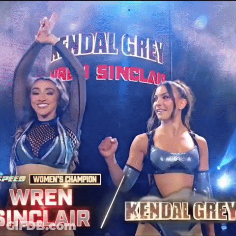 Two Women Are Standing Next To Each Other In Front Of A Banner That Says Kendal Grey GIF