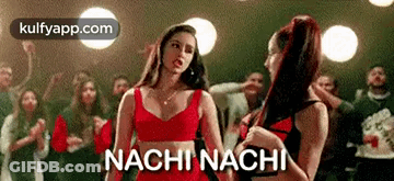 Two Women Are Standing Next To Each Other In Front Of A Crowd And The Words Nachi Nachi Are Written On The Screen . GIF