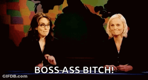 Two Women Are Standing Next To Each Other In Front Of A Map And A Sign That Says `` Bitches Get Stuff Done '' . GIF